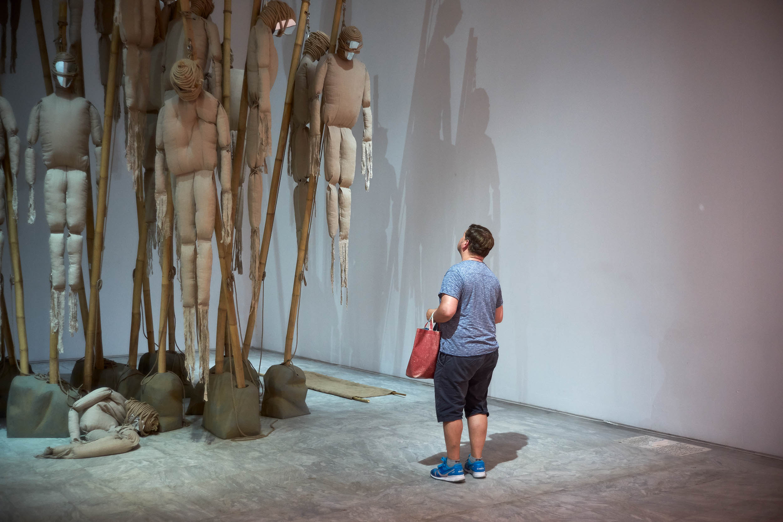 A visitor viewing the installation Zombification by Kettly Noël, Athens Conservatoire (Odeion), Athens, 2017