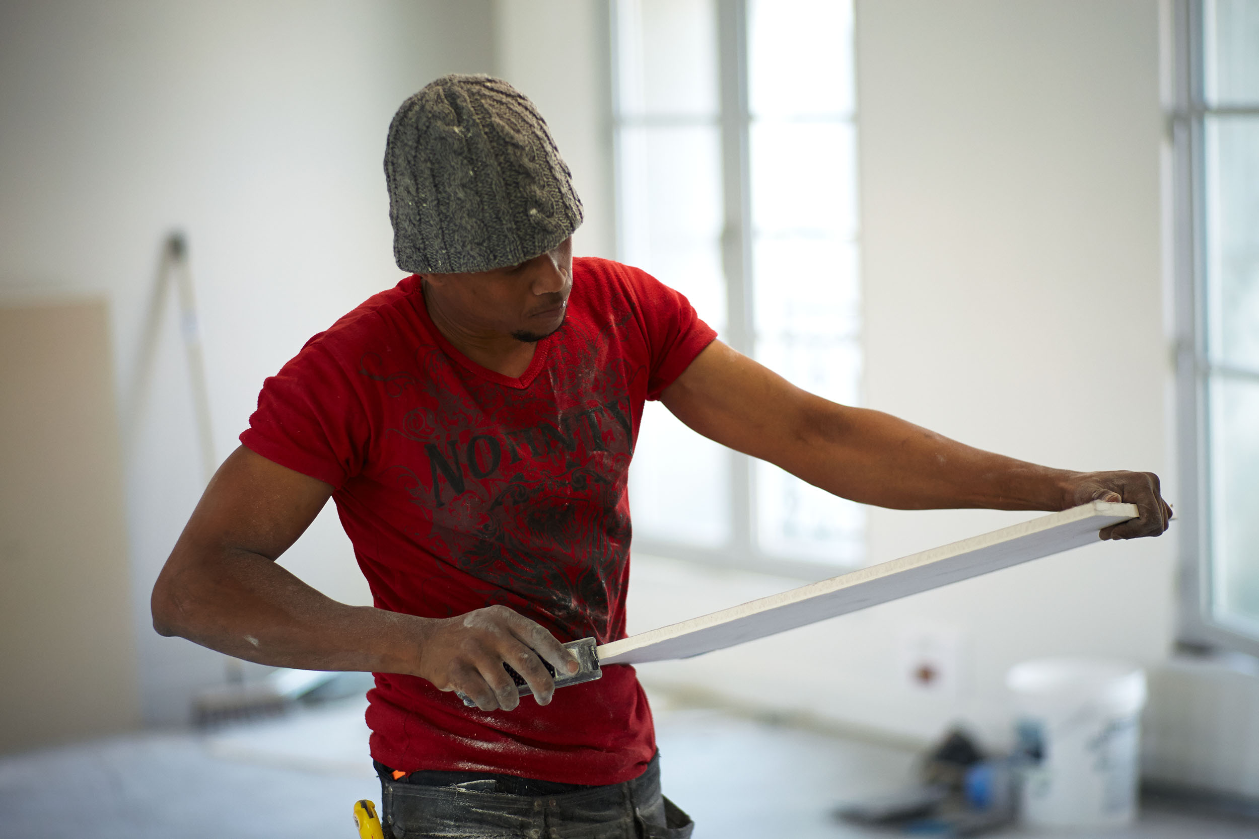 Worker preparing the cutting of insulation panels for partitions, construction site of the new Cheuvreux headquarters